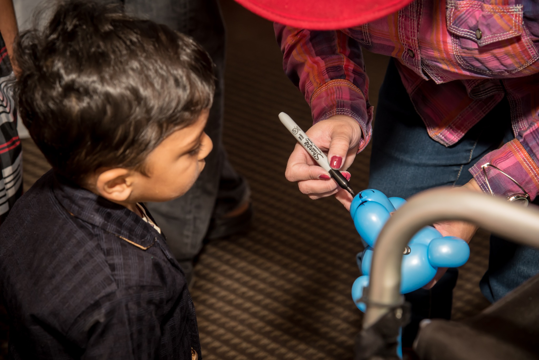 Balloon artist creating a balloon for a child