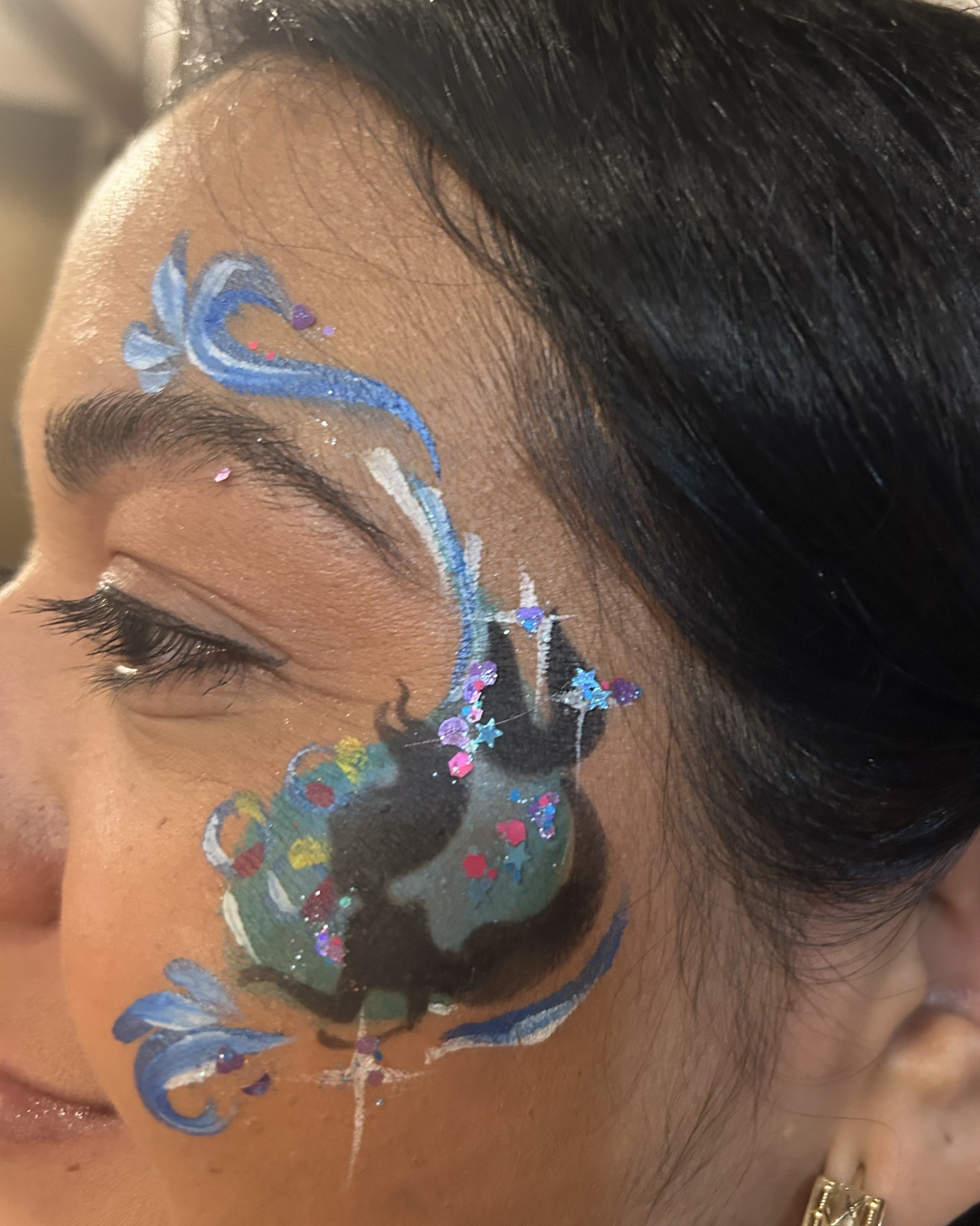 Blue peacock-inspired face painting