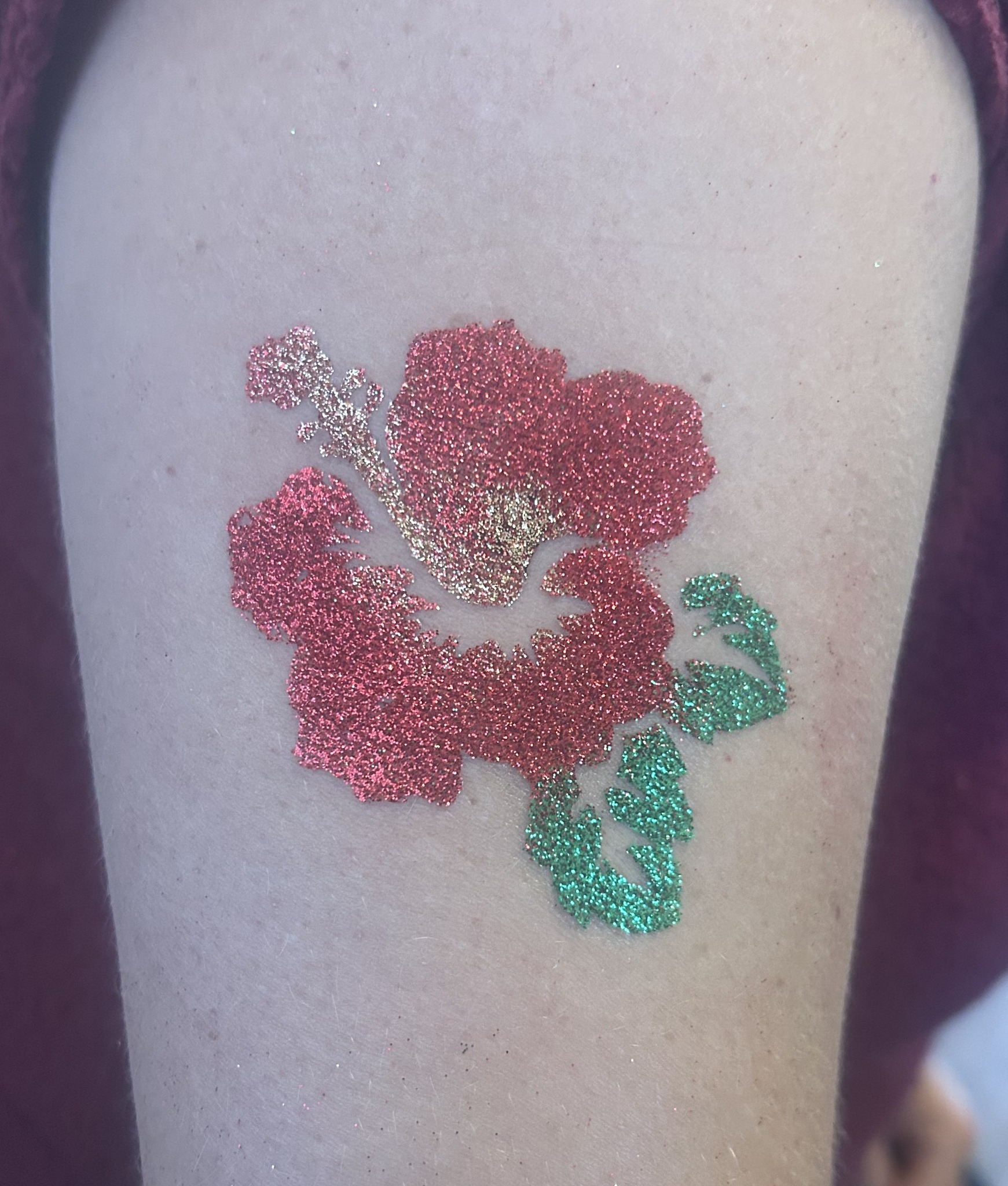 Red and green hibiscus glitter tattoo